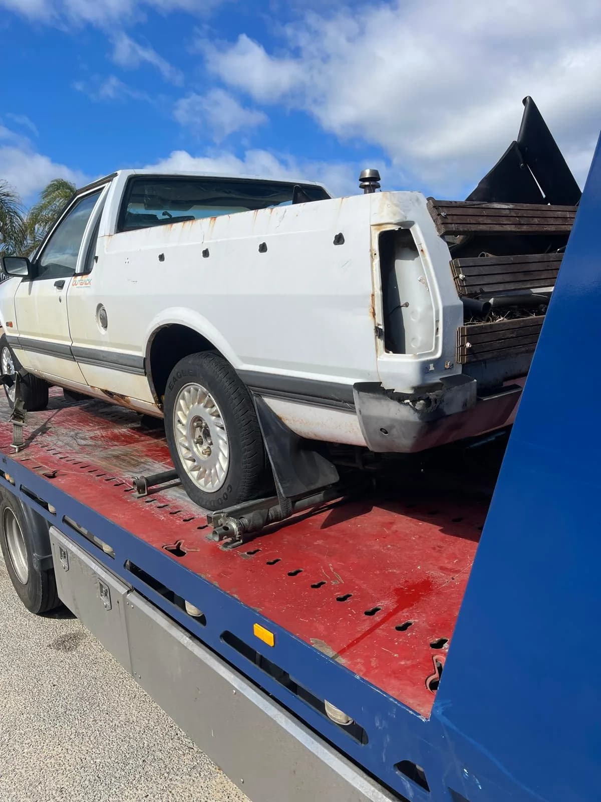 Broken Holden ute secured on an iCar Removals tilt tray truck after collection in Port Kennedy